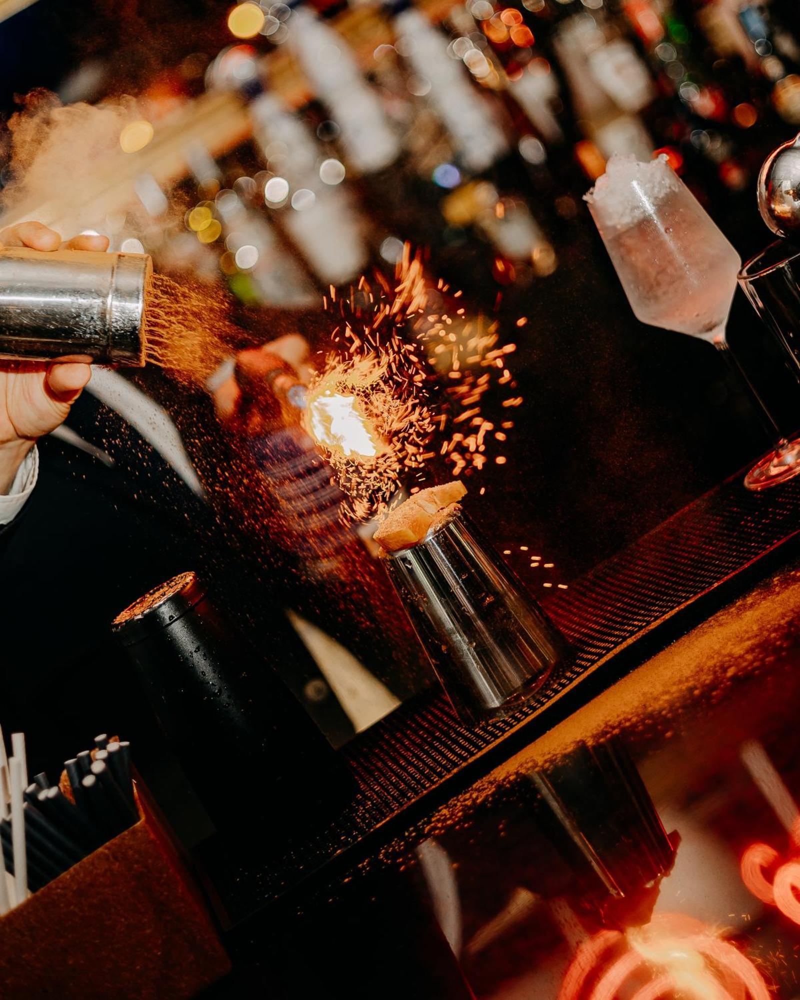 138 Liberdade Hotel Лісабон Екстер'єр фото A bartender using a cocktail gun to make a flaming shot